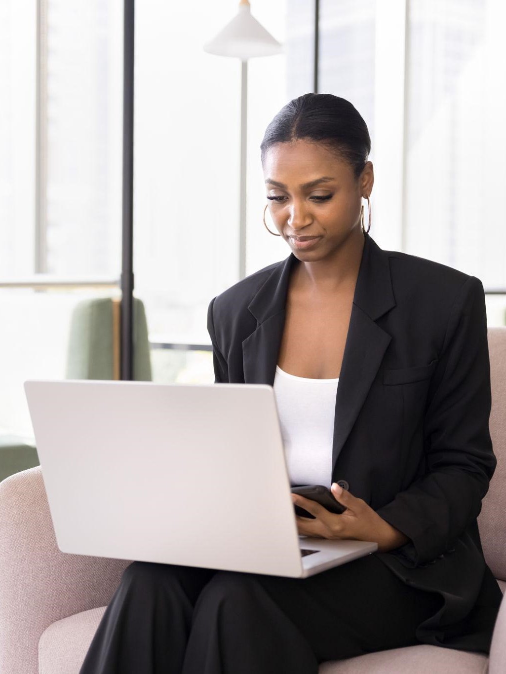 Woman managing her order on laptop and phone